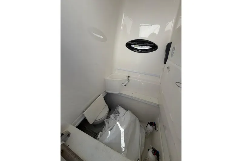 Slide: The Image of Compact boat bathroom with toilet, sink, and storage space, Contender 2021 model. - 10