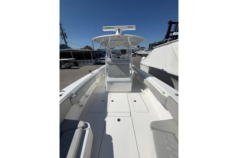 Slide: The Image of 2021 Contender boat with spacious deck and Garmin radar, docked under clear blue sky. - 17