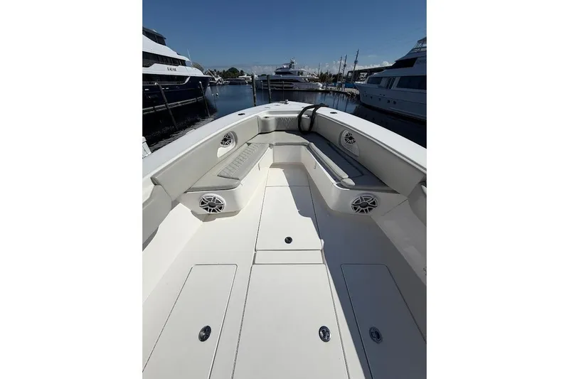 Slide: The Image of 2021 Contender boat interior with seating and speakers, docked among yachts. - 18