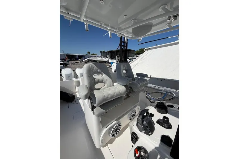 Slide: The Image of 2021 Contender boat cockpit with dual seats, steering wheel, and control panel. - 21
