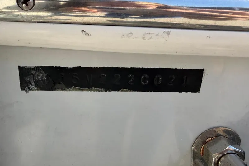 Slide: The Image of Hull identification number on a 2021 Contender boat, partially obscured. - 22
