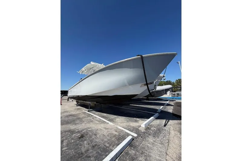 Slide: The Image of 2021 Contender boat on trailer under clear blue sky. - 3