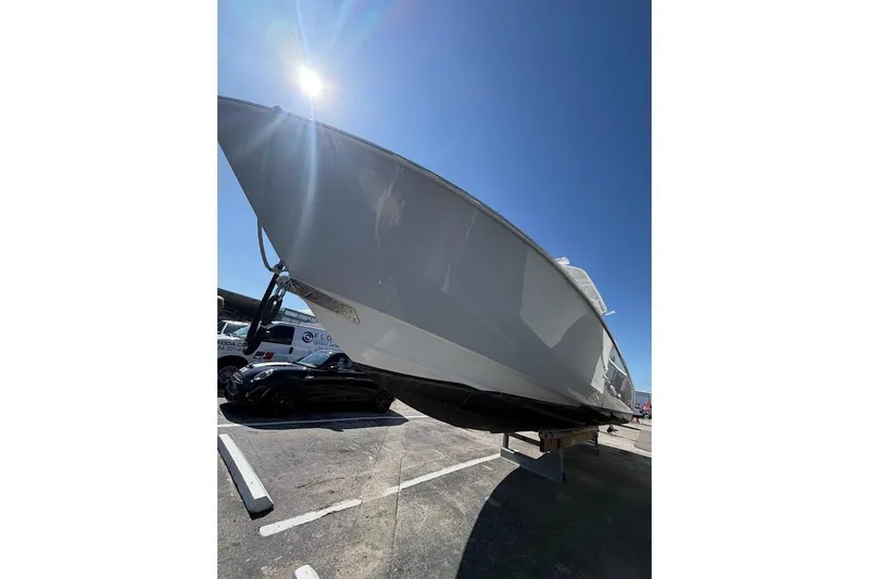 Slide: The Image of 2021 Contender boat on trailer under bright sunlit sky. - 4