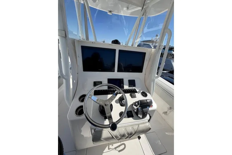 Slide: The Image of Center console of a 2021 Contender boat with dual screens and steering wheel. - 7