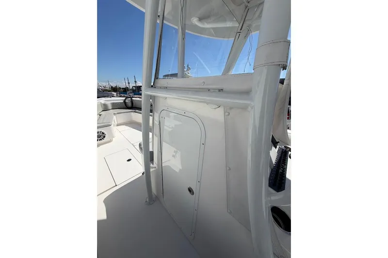 Slide: The Image of 2021 Contender boat interior with white console and seating area under clear blue sky. - 8