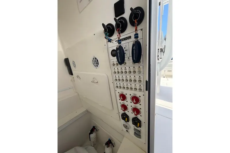 Slide: The Image of Control panel of a 2021 Contender boat, featuring switches and safety equipment. - 9