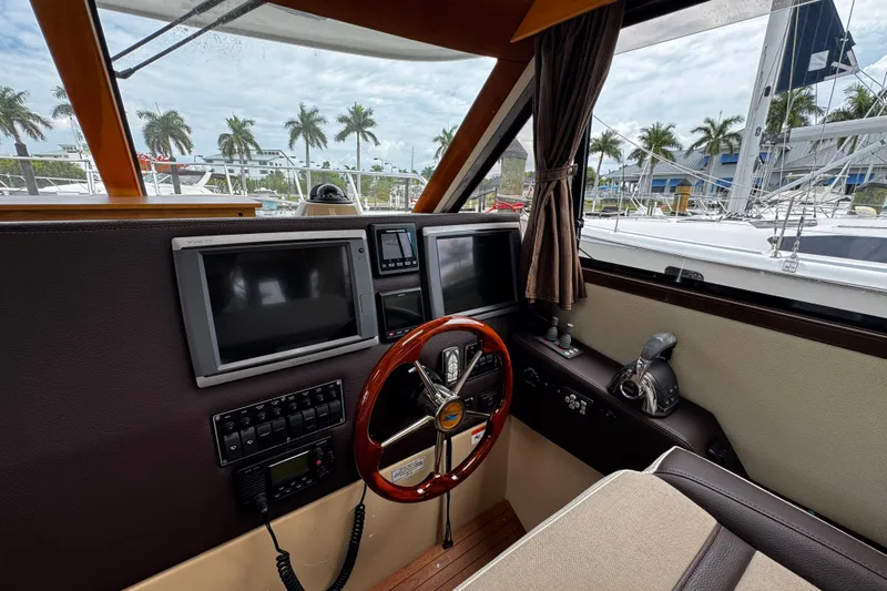 Slide: The Image of Interior helm of 2015 Cutwater 30 Sedan with navigation screens and steering wheel. - 13