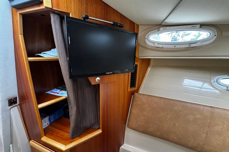 Slide: The Image of Interior of 2015 Cutwater 30 Sedan with TV, shelves, and porthole window. - 15