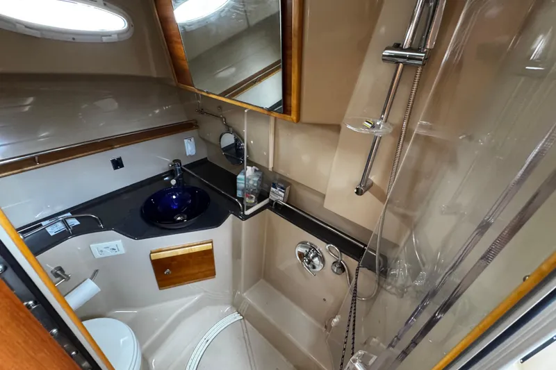Slide: The Image of Luxurious bathroom in 2015 Cutwater 30 Sedan yacht with modern fixtures and elegant design. - 16