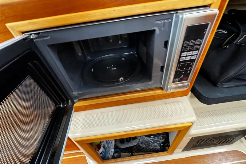 Slide: The Image of Open microwave in 2015 Cutwater 30 Sedan boat interior kitchen area. - 20
