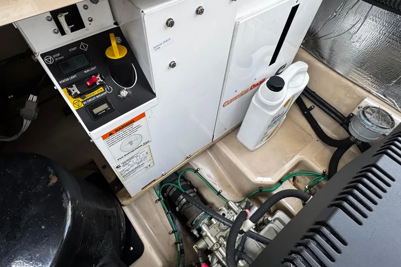 Slide: The Image of Engine room of a 2015 Cutwater 30 Sedan with Cummins Onan generator and maintenance supplies. - 23