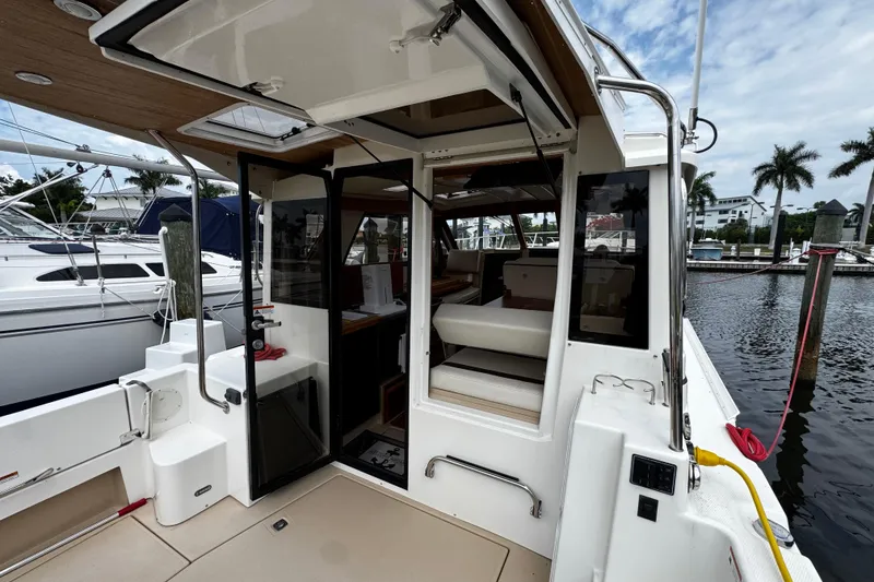 Slide: The Image of 2015 Cutwater 30 Sedan boat interior with open cabin door at marina. - 5