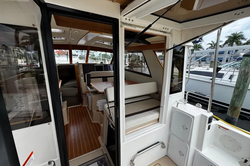 Slide: The Image of Interior view of a 2015 Cutwater 30 Sedan boat, showcasing seating and helm area. - 6