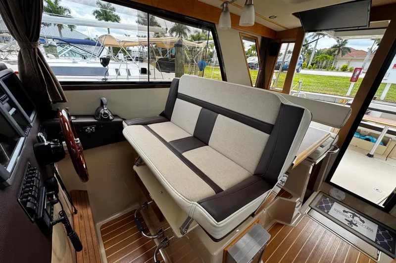 Slide: The Image of Interior of 2015 Cutwater 30 Sedan boat with helm and seating area. - 9