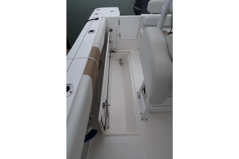 Slide: The Image of Interior view of a 2017 Edgewater 245CC boat, showcasing seating and storage area. - 10