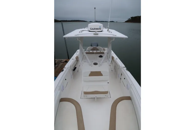 Slide: The Image of 2017 Edgewater 245CC boat with Garmin equipment, docked on a calm lake. - 12