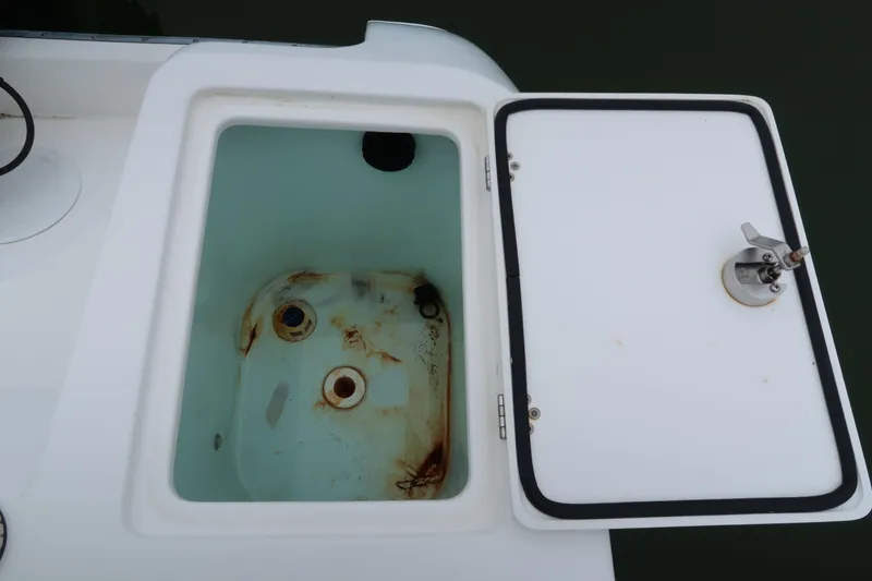 Slide: The Image of Open storage compartment on 2017 Edgewater 245CC boat, showing interior details. - 4