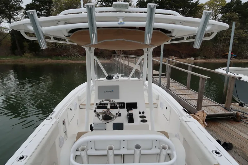 Slide: The Image of 2017 Edgewater 245CC boat at dock, featuring a Garmin navigation system. - 6