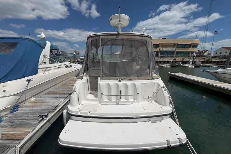 Slide: The Image of 1999 Chaparral Signature 300 boat docked at marina under blue sky. - 3