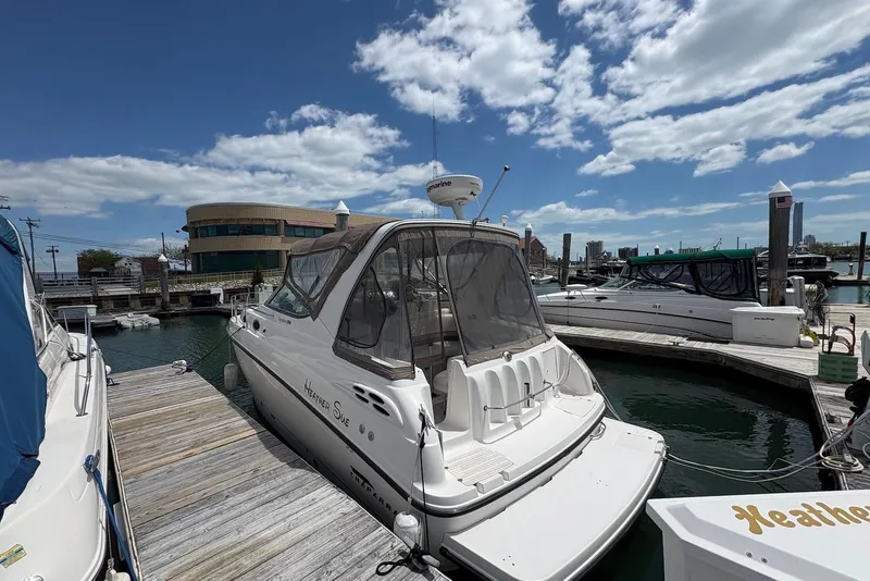 Slide: The Image of 1999 Chaparral Signature 300 docked at marina under blue sky. - 4