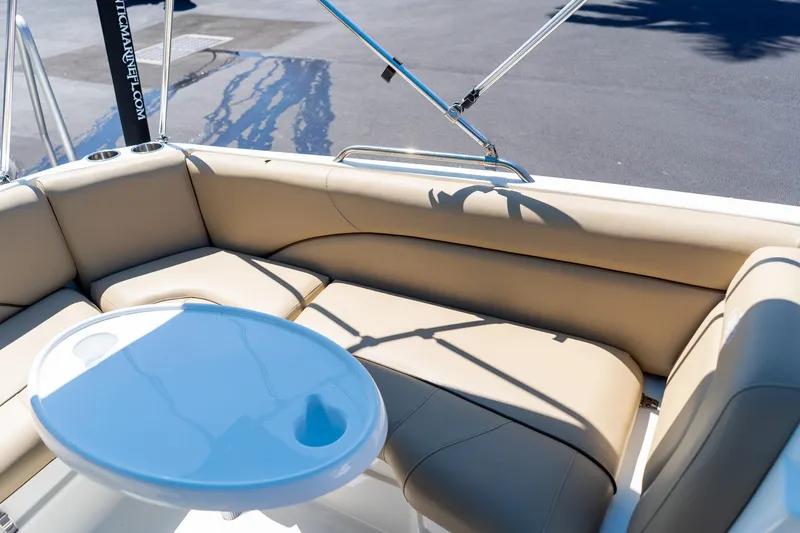 Slide: The Image of Interior seating of 2020 NauticStar 203 SC boat with beige upholstery and table. - 14