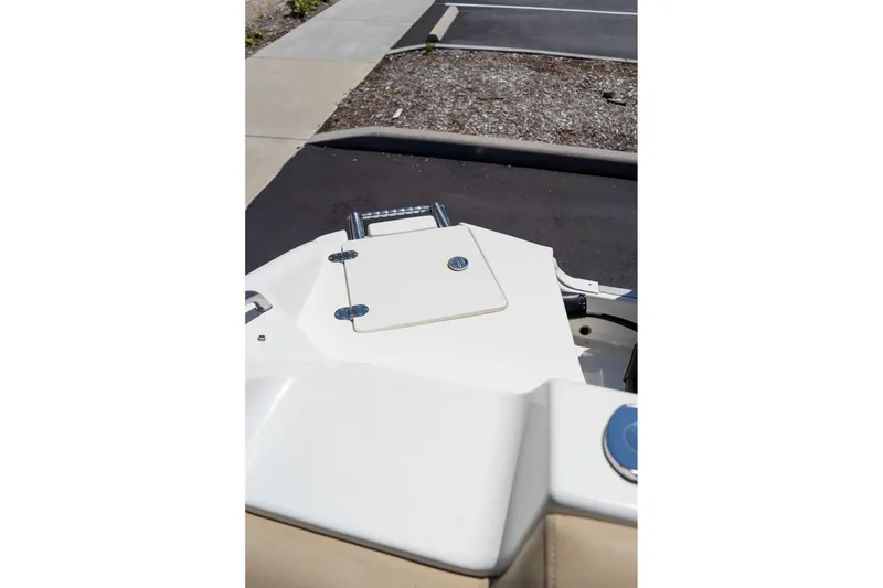 Slide: The Image of 2020 NauticStar 203 SC boat deck with hatch and ladder in parking area. - 19