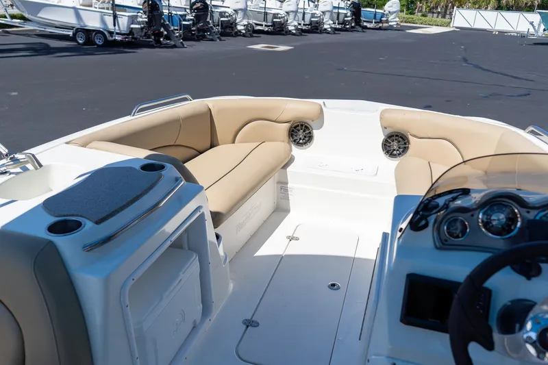 Slide: The Image of 2020 NauticStar 203 SC boat interior with beige seating and dashboard view. - 20