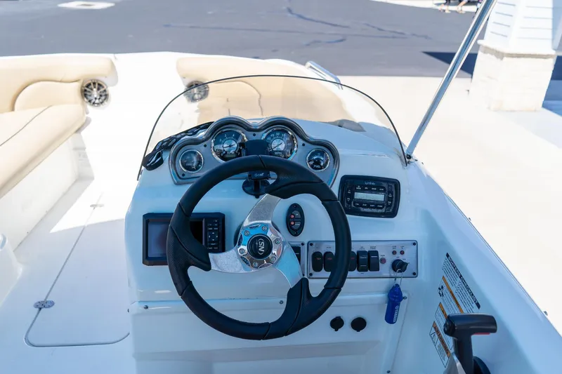 Slide: The Image of Cockpit view of 2020 NauticStar 203 SC boat with steering wheel and dashboard controls. - 21