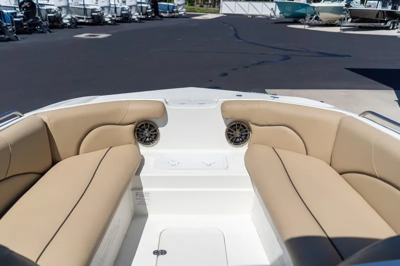 Slide: The Image of 2020 NauticStar 203 SC boat interior with tan seating and speakers. - 26