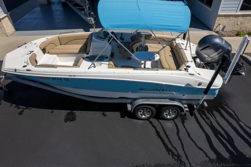Slide: The Image of 2020 NauticStar 203 SC boat on trailer with blue canopy and Yamaha engine. - 3