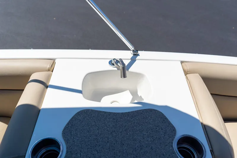 Slide: The Image of 2020 NauticStar 203 SC boat interior with sink and cup holders. - 32