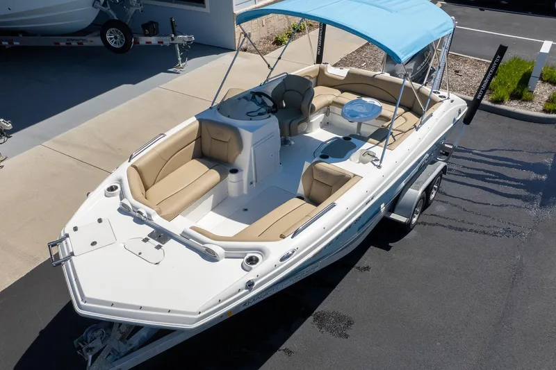 Slide: The Image of 2020 NauticStar 203 SC boat with blue canopy and beige seating on trailer. - 4