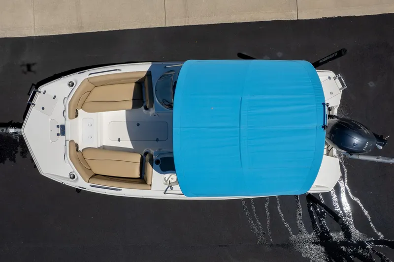 Slide: The Image of Aerial view of 2020 NauticStar 203 SC boat with blue canopy and beige seating. - 6