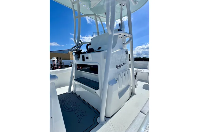 Slide: The Image of 2026 BlackJack 256 Coastal boat console under clear blue sky. - 11