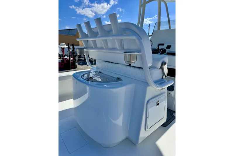 Slide: The Image of 2026 BlackJack 256 Coastal boat interior with rod holders and seating under a clear blue sky. - 13