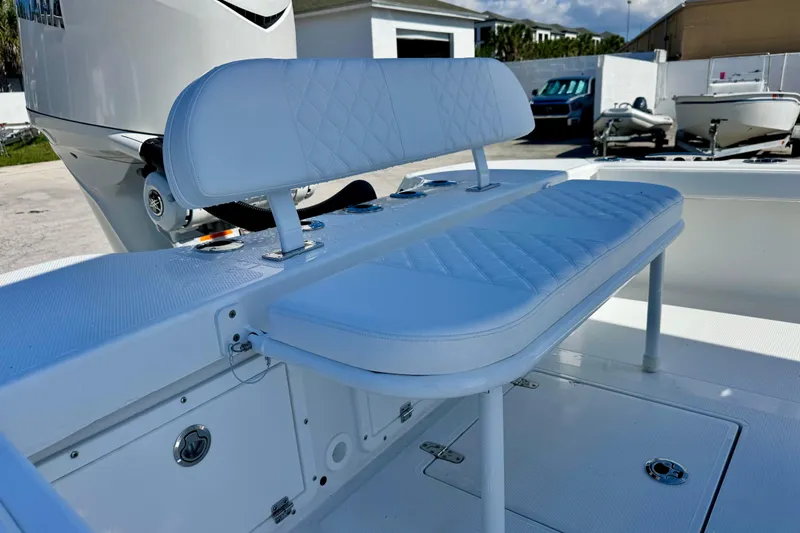 Slide: The Image of 2026 BlackJack 256 Coastal boat with white cushioned seating and Yamaha engine. - 14