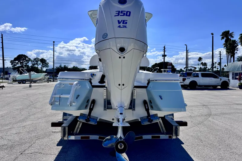 Slide: The Image of 2026 BlackJack 256 Coastal boat with powerful 350 V6 engine, parked outdoors. - 3