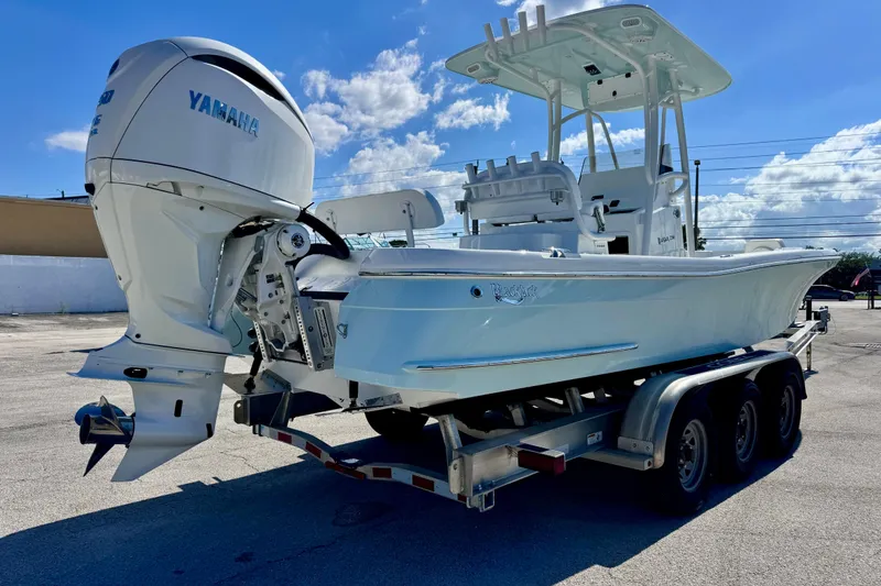 Slide: The Image of 2026 BlackJack 256 Coastal boat on trailer with Yamaha outboard motor under blue sky. - 4