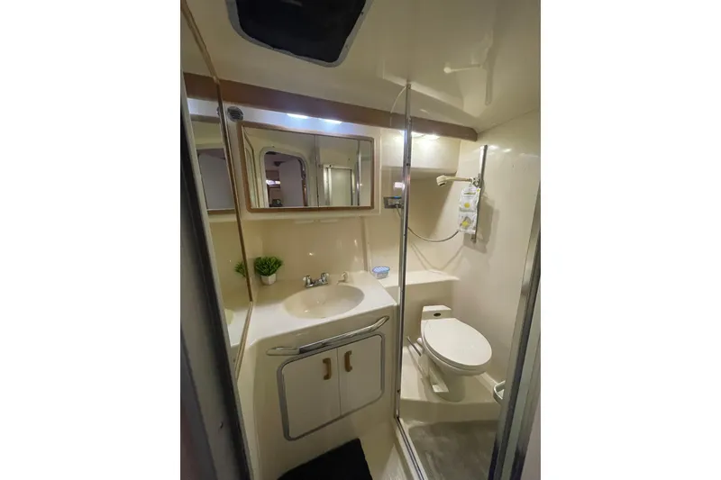 Slide: The Image of Bathroom interior of 1992 Sea Ray 370 Express Cruiser with sink, toilet, and shower. - 10