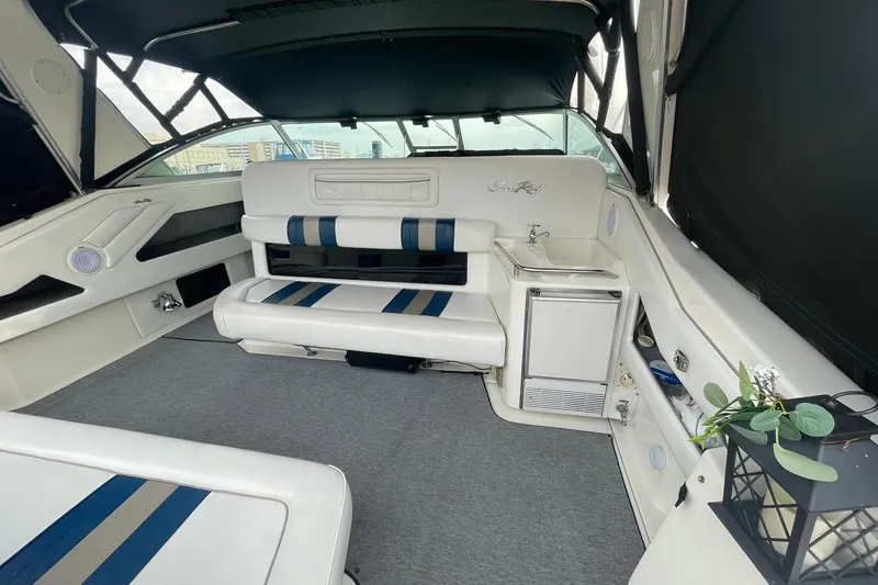 Slide: The Image of Interior of a 1992 Sea Ray 370 Express Cruiser with seating and kitchenette. - 12