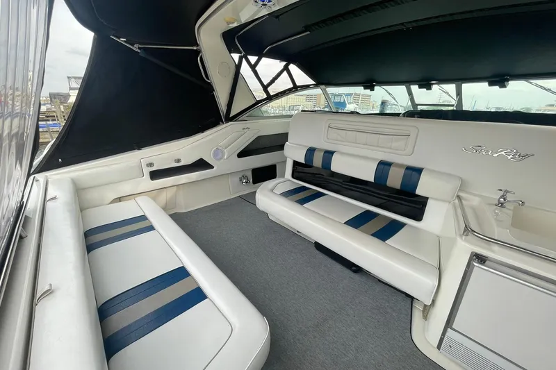 Slide: The Image of Interior of a 1992 Sea Ray 370 Express Cruiser with white and blue seating. - 13