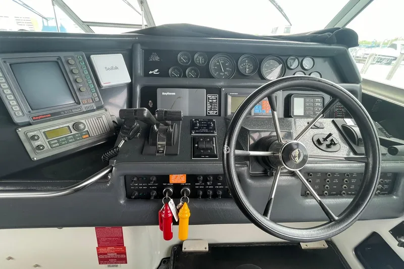 Slide: The Image of Cockpit of 1992 Sea Ray 370 Express Cruiser with steering wheel and navigation instruments. - 14