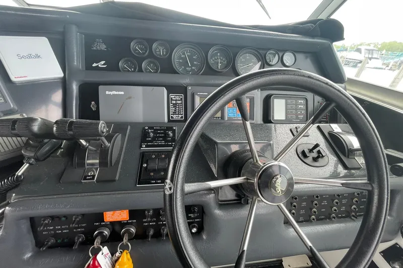 Slide: The Image of Cockpit of 1992 Sea Ray 370 Express Cruiser with steering wheel and navigation instruments. - 15