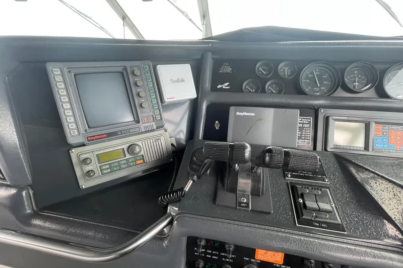 Slide: The Image of Control panel of a 1992 Sea Ray 370 Express Cruiser with navigation and communication equipment. - 16