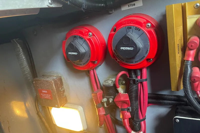Slide: The Image of Red Perko battery switches in a 1992 Sea Ray 370 Express Cruiser engine compartment. - 18