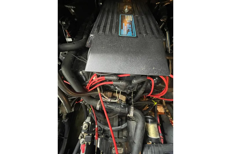 Slide: The Image of Engine compartment of a 1992 Sea Ray 370 Express Cruiser with visible wiring and components. - 19