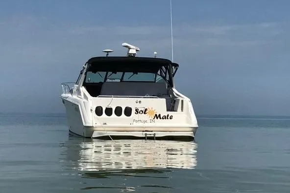 Slide: The Image of 1992 Sea Ray 370 Express Cruiser on calm water, rear view. - 2