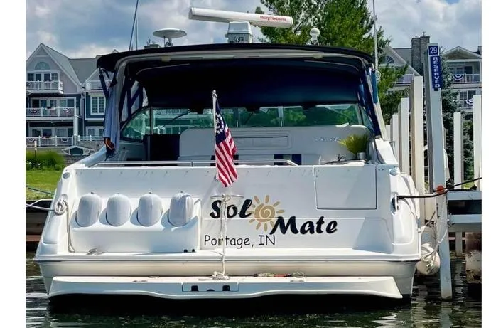 Slide: The Image of 1992 Sea Ray 370 Express Cruiser docked, displaying "Sol Mate" and American flag. - 3