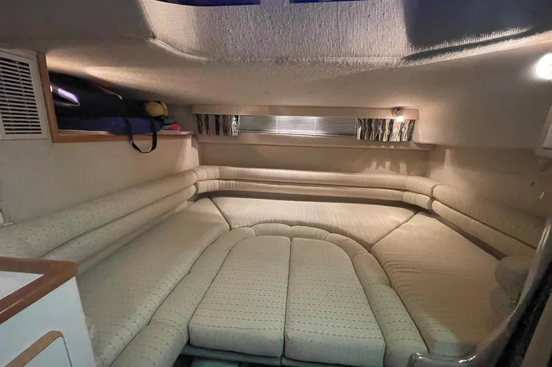 Slide: The Image of Interior cabin of a 1992 Sea Ray 370 Express Cruiser, featuring cozy seating and soft lighting. - 4