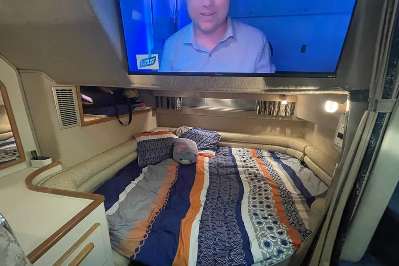 Slide: The Image of Interior cabin of a 1992 Sea Ray 370 Express Cruiser with a cozy bed and TV. - 5